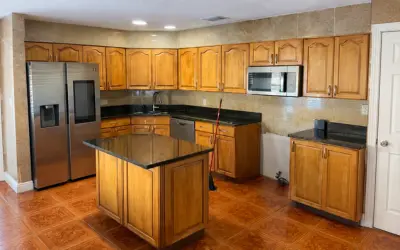 Before Kitchen cabinet refinishing in progress in Kissimmee, FL by Castillo Epoxy Refinishing