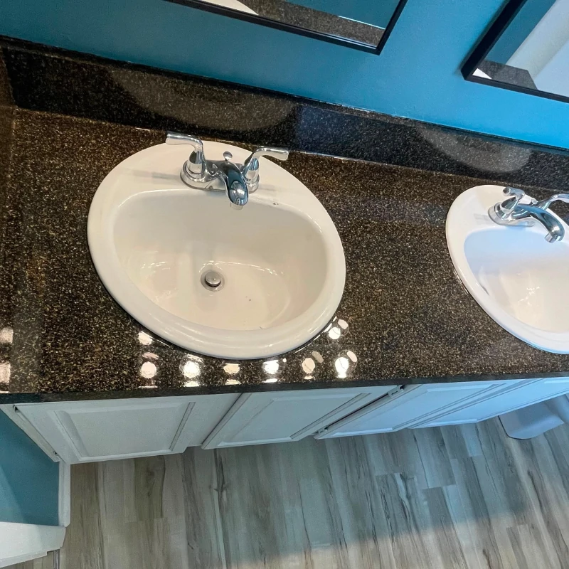 dark-granite-epoxy-countertop-resurfacing-after-kissimmee. Refinished dark granite multi-stone epoxy vanity countertop in Kissimmee FL