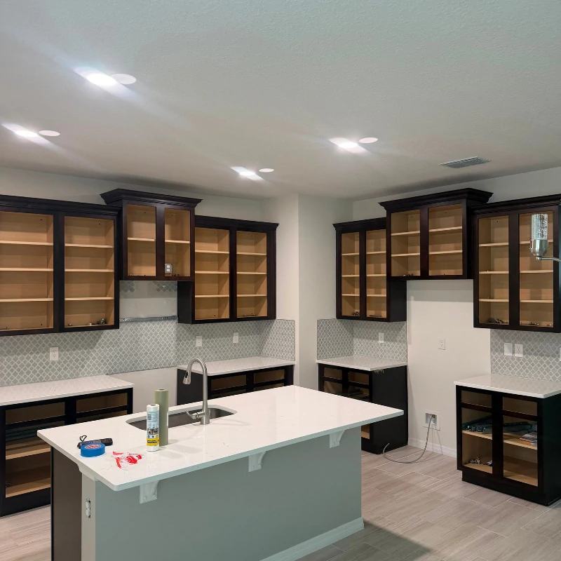 dark-kitchen-cabinet-refinishing-before-kissimmee. Dark wood kitchen cabinets prepped for factory coating in Kissimmee FL