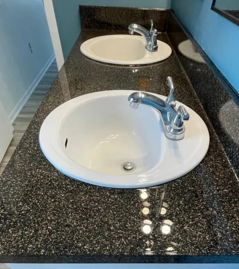 Refinished double sink vanity top with dark granite fleck finish in Kissimmee FL.