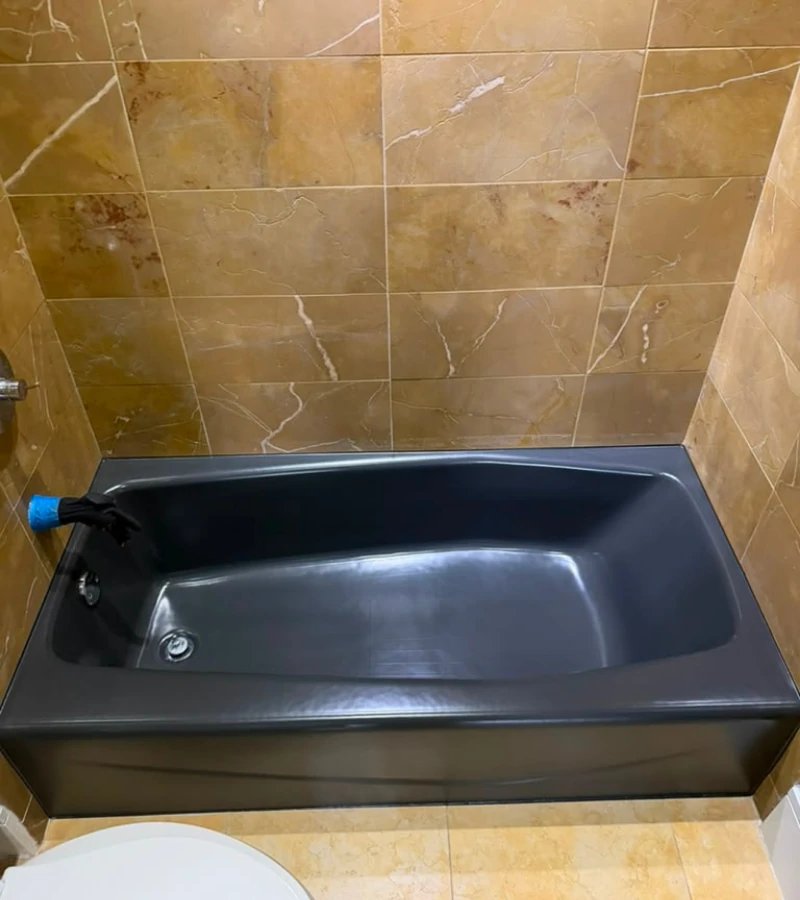 Restored black epoxy coating on fiberglass bathtub in Kissimmee FL.