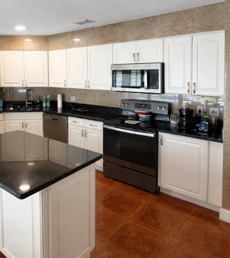After cabinet refinishing: Modernized kitchen featuring sleek off-white repainted cabinets with a durable, smooth finish.