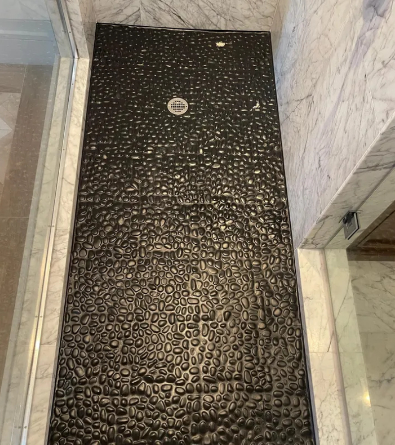 Refinished black epoxy pebble shower floor in Kissimmee FL.