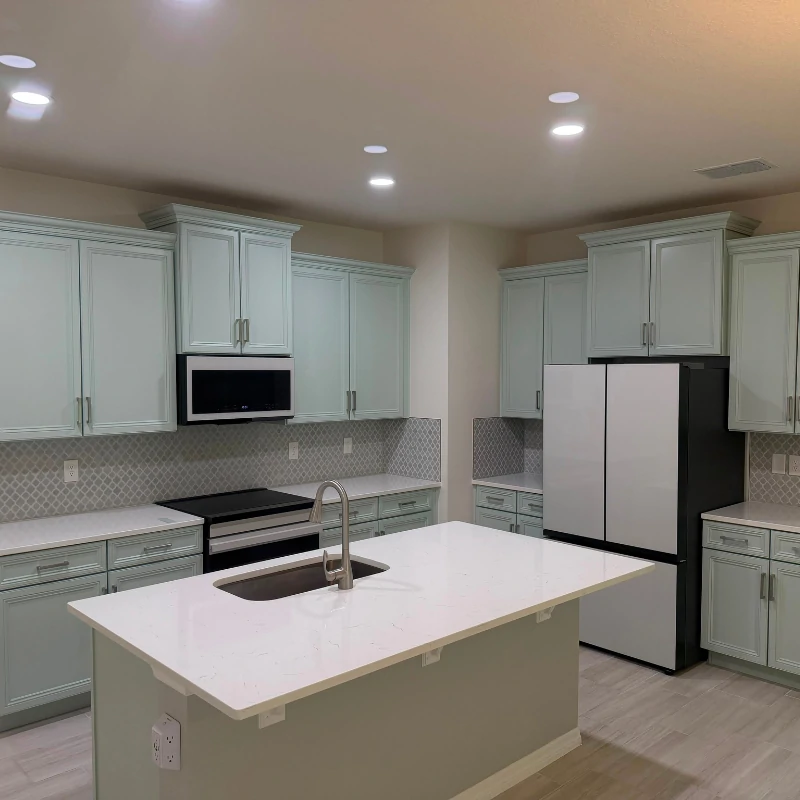 sage-green-kitchen-cabinet-painting-after-kissimmee. Refinished light sage green kitchen cabinets and island in Kissimmee FL