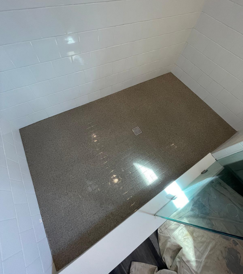 Resurfaced tile shower pan with granite fleck coating in Kissimmee FL.